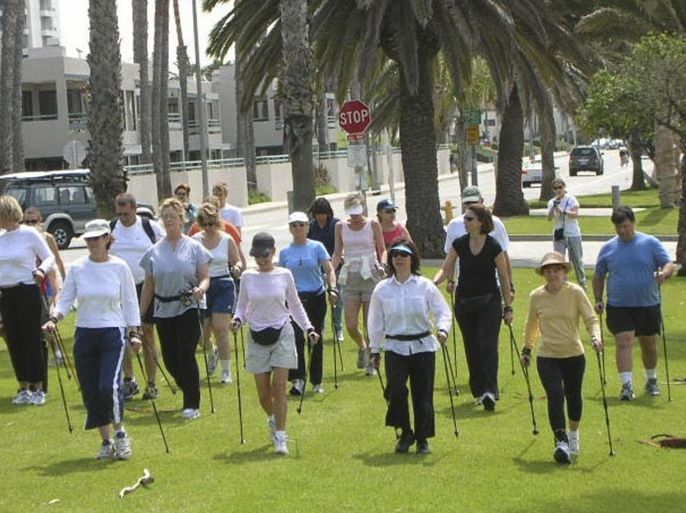 A Nordic Walking class is shown in this April 2005 handout photograph in Santa Monica, California, provided by Nordic Body Inc on October 10, 2014. Nordic walking, or walking with poles, is an effective, full body workout, fitness experts say but it has a bit of an image problem. The activity burns more calories and works more muscles than walking alone, but to embark on a public trek that looks like cross-country skiing without the snow can require a modicum of unselfconscious courage. To match FITNESS-NORDICWALKING/ REUTERS/Nordic Body Inc/Handout via Reuters (UNITED STATES - Tags: SOCIETY HEALTH EDUCATION SPORT) ATTENTION EDITORS - THIS PICTURE WAS PROVIDED BY A THIRD PARTY. REUTERS IS UNABLE TO INDEPENDENTLY VERIFY THE AUTHENTICITY, CONTENT, LOCATION OR DATE OF THIS IMAGE. FOR EDITORIAL USE ONLY. NOT FOR SALE FOR MARKETING OR ADVERTISING CAMPAIGNS. THIS PICTURE IS DISTRIBUTED EXACTLY AS RECEIVED BY REUTERS, AS A SERVICE TO CLIENTS. NO SALES. NO ARCHIVES