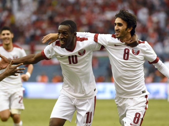 Qatar footballer Ali Assadalla (R) celebrates after scoring a goal against Oman during the semi-final of the 22nd Gulf Cup football match at King Fahad stadium in Riyadh on November 23, 2014. AFP PHOTO/ FAYEZ NURELDINE