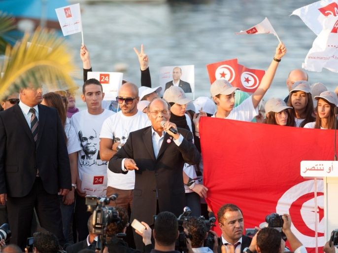 Presidential candidate and Tunisian President, Moncef Marzouki, addresses his supporters during a campaign meeting in Bizerte, northern Tunisia, Wednesday, Nov. 19, 2014. The presidential campaign, featuring 25 competitors, kicked off in early November and it's the first time since Tunisians overthrew dictator Zine El Abidine Ben Ali in 2011 that they will choose their head of state through universal suffrage. If no candidate wins a majority Nov. 23, there will be a runoff between the top two vote-getters on Dec. 28. (AP Photo/Aimen Zine)