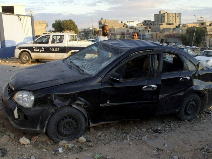 A car which crashed in front of the entrance to the National Security Directorate of Tobruk following a car bomb explosion is seen in Tobruk October 28, 2014. There were no casualties from the explosion on Tuesday, a witness said. REUTERS/Stringer (LIBYA - Tags: CIVIL UNREST POLITICS)