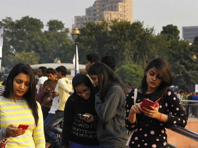 NEW DELHI, INDIA - NOVEMBER 16: Visitors busy on mobile phones after Tata Docomo, the unified telecom brand of Tata Teleservices Limited, launched public wi-fi access in association with the New Delhi Municipal Council, at Central Park, Connaught Place, on November 16, 2014 in New Delhi, India. The visitors can avail the facility by filling in details such as email ID and mobile number.