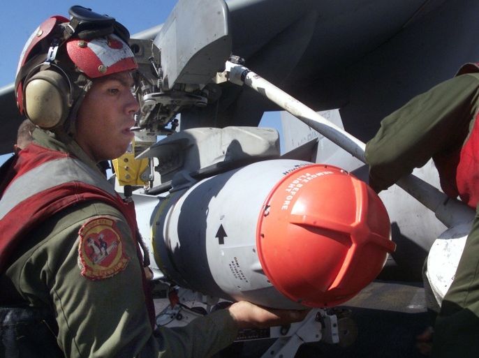 396957 01: U.S. Marine Ordnance technicians load an AGM-65 'Maverick' missile on the wing of an AV-8B 'Harrier' onboard the USS Peleliu prior to a mission over Afghanistan November 2, 2001 in support of Operation Enduring Freedom.