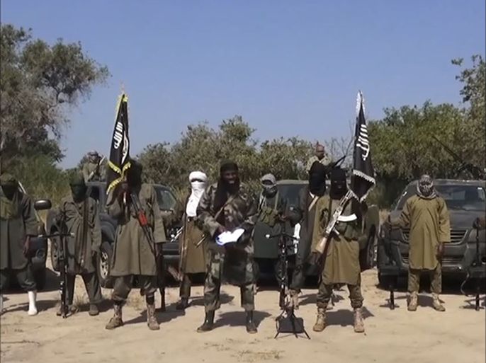 An image grab made on October 31, 2014 from a video obtained by AFP shows the leader of the Islamist extremist group Boko Haram Abubakar Shekau (C) delivering a speech. Boko Haram denied that they had agreed to a ceasefire in a new video obtained on October 31 by AFP