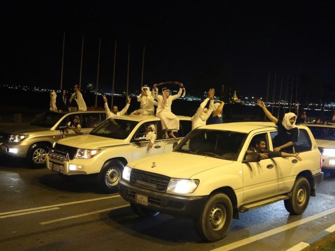 DOHA, QATAR - NOVEMBER 26: Qatari people celebrate after winning over Saudi Arabia at the final of the 22nd Gulf Cup football match in Doha, Qatar on November26,2014.