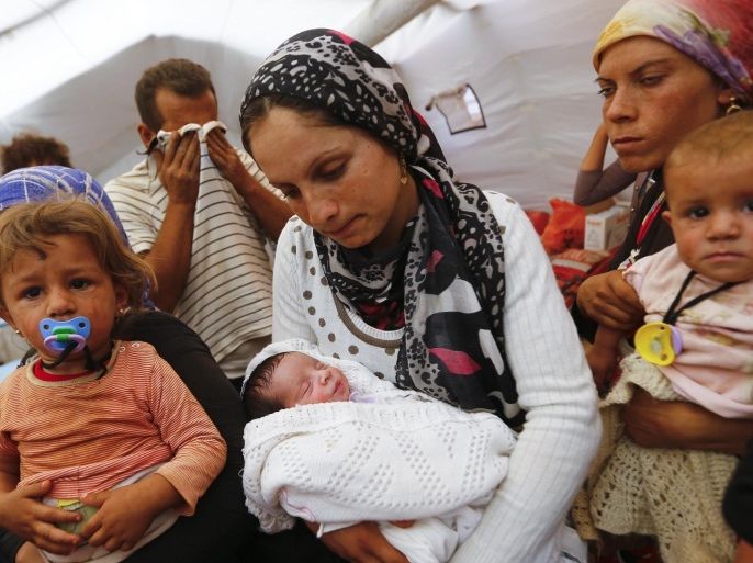Kurdish Syrian refugees are seen with children inside a temporary medical facility for children on the Turkish-Syrian border near the southeastern town of Suruc in Sanliurfa province, in this September 24, 2014 file photo. Reuters photographers have chronicled Kurdish refugee crises over the years. In 1991 Srdjan Zivulovic documented refugees in Cukurca who had escaped a military operation by Saddam Hussein's government in Iraq aimed at "Arabising" Kurdish areas in the north. Hundreds of thousands fled into Turkey and Iran. Images shot in recent months show familiar scenes as crowds of people flee Islamic State militants in Syria. There are as many as 30 million Kurds, spread through Turkey, Iraq, Syria and Iran. Most Kurds are Sunni Muslims, but tend to feel more loyalty to their Kurdishness, rather than their religion. REUTERS/Murad Sezer/Files (TURKEY - Tags: SOCIETY IMMIGRATION POLITICS CONFLICT) ATTENTION EDITORS: PICTURE 18 OF 30 PICTURES FOR WIDER IMAGE STORY 'KURDISH REFUGEES - THEN AND NOW'SEARCH 'CUKURCA' FOR ALL IMAGES
