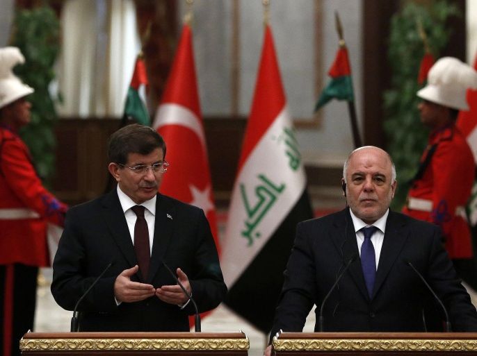 BAGHDAD, IRAQ - NOVEMBER 20: Iraqi Prime Minister Haider al-Abadi (R) and Turkey's Prime Minister Ahmet Davutoglu (L) hold a press conference in Baghdad, Iraq, on November 20, 2014 . Davutoglu pays a two day official visit to Iraq.