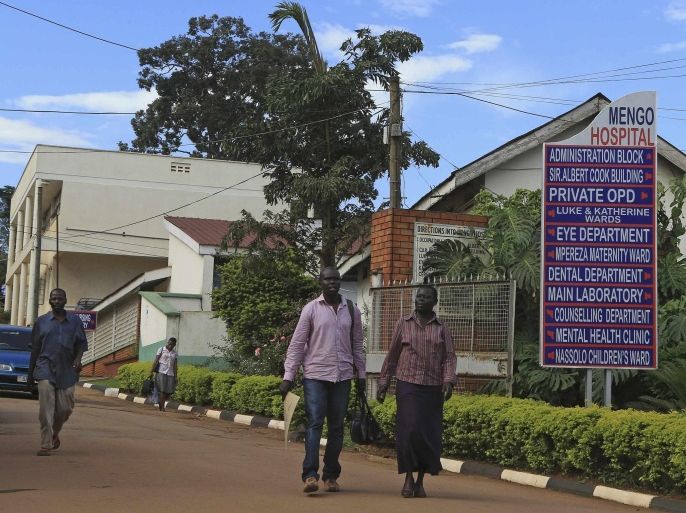 People walk in Mengo Hospital, where an employee died from the Ebola-like Marburg virus, in the Uganda capital Kampala October 6, 2014. The 30-year old radiographer died in Uganda's capital after an outbreak of Marburg, a highly infectious hemorrhagic fever similar to Ebola, authorities said on Sunday, adding that a total of 80 people who came into contact with him were quarantined. Marburg starts with a severe headache followed by haemorrhaging and leads to death in 80 percent or more of cases in about nine days. It is from the same family of viruses as Ebola, which has killed thousands in West Africa in recent months. The health ministry said in a statement that the man died on Sept. 28 while working at the hospital. REUTERS/James Akena (UGANDA - Tags: DISASTER HEALTH SOCIETY)