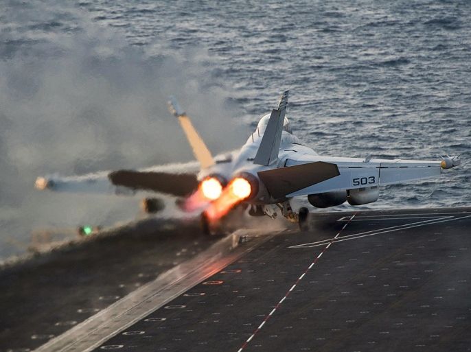 An EA-18G Growler launches from the Nimitz-class aircraft carrier USS Carl Vinson (CVN 70) in this U.S. Navy picture taken in the Arabian Gulf October 28, 2014. The United States targeted Islamic State militants on Sunday and Monday with five air strikes in Syria and nine in Iraq, according to U.S. Central Command.  Picture taken October 28, 2014.   REUTERS/U.S. Navy/Mass Communication Specialist 2nd Class John Philip Wagner Jr./Handout via Reuters  (MID-SEA - Tags: MILITARY CONFLICT) THIS IMAGE HAS BEEN SUPPLIED BY A THIRD PARTY. IT IS DISTRIBUTED, EXACTLY AS RECEIVED BY REUTERS, AS A SERVICE TO CLIENTS. FOR EDITORIAL USE ONLY. NOT FOR SALE FOR MARKETING OR ADVERTISING CAMPAIGNS
