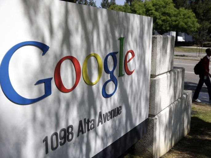 FILE - In this June 5, 2014 file photo, a man walks past a Google sign at the company's headquarters in Mountain View, Calif., U.S.A. The politically-fraught issue of forcing big, multinational companies to pay more tax will be high on the agenda at G-20 summit on Nov. 15 and 16 in Brisbane, Australia. There has been an ongoing effort by governments to crack down on tax avoidance, with companies such as Google and Amazon facing criticism for moving profits earned in one country to other countries with lower tax rates. (AP Photo/Marcio Jose Sanchez, File)