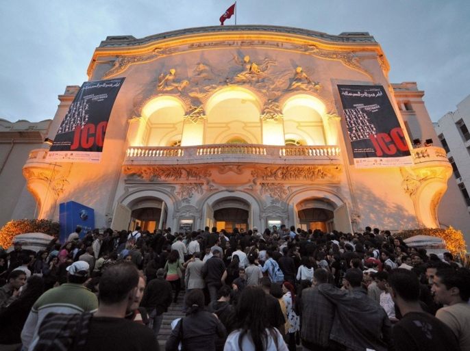 People are pictured in front of a cinema during the 22nd Carthage film festival (JCC) on October 31, 2008 in Tunis.