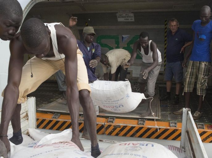 In this photo of Friday, July 25, 2014, Workers unloading grain for food distribution from a WFP plane in Malakal, South Sudan. Health experts are meeting in South Sudan’s capital, Juba, Monday July 28, 2014, debating exactly how severe the famine situation is in South Sudan, and their decision may prompt millions of dollars in aid or condemn tens of thousands of displaced people to continued hunger in what is described by Chris Hillbruner, the lead food security analyst for FEWSNET, a famine early warning system "is still the worst food security emergency in the world ... there is still huge need." (AP Photo/ Matthew Abbott)