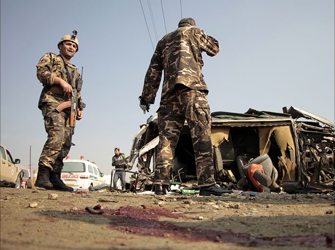 epa04505437 Afghan security officials inspect the scene of a sicide bomb attack that targeted a vehicle of the British embassy, in Kabul, Afghanistan, 27 November 2014. At least four persons were killed when a suicide bomber exploded himself targeting a vehicle of British embassy. A spokesman for the embassy confirmed the attack, but said there was no diplomat in the vehicle. EPA/HEDAYATULLAH AMID
