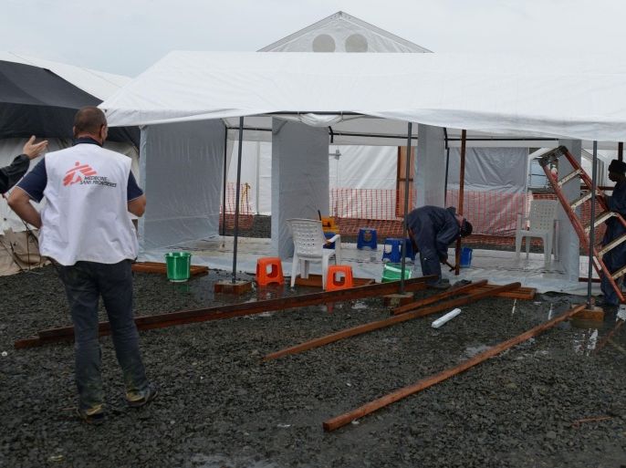Workers set up a new medical tent on September 7, 2014 at Elwa hospital in Monrovia, which is run by the non-governmental international organization Medecins Sans Frontieres (Doctors without Borders -- MSF). US President Barack Obama said in an interview aired on September 7 the US military would help in the fight against fast-spreading Ebola in Africa, but warned it would be months before the epidemic slowed. The tropical virus, transmitted through contact with infected bodily fluids, has killed 2,100 people in four countries since the start of the year -- more than half of them in Liberia. AFP PHOTO / DOMINIQUE FAGET