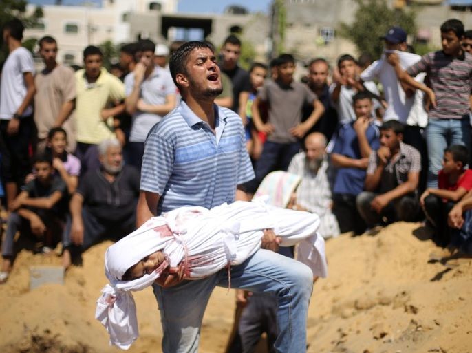 ATTENTION EDITORS - VISUAL COVERAGE OF SCENES OF INJURY OR DEATHRNPS - REUTERS NEWS PICTURE SERVICE - PICTURES OF THE YEAR 2014A Palestinian man reacts as he carries the body of a girl from the Abu Nejim family, whom medics said was killed along with other eight family members by an Israeli air strike, before her burial at a cemetery in Beit Lahiya in the northern Gaza Strip, in this August 4, 2014 file photo. REUTERS/Mohammed Salem/Files (GAZA - Tags: POLITICS CIVIL UNREST TPX IMAGES OF THE DAY) TEMPLATE OUT