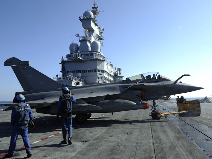 French Marines prepare a Rafale jet fighter on the deck of the French aircraft carrier Charles De Gaulle on March 25, 2011 during the 'Odyssey Dawn' operations in Libya. French President said on March 25, 2011 France and Britain were readying a 'political and diplomatic' solution on Libya.