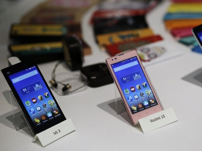 Three models of China's Xiaomi Mi phones are pictured during their launch in New Delhi in this July 15, 2014 file photo. The court order that banned Chinese mobile maker Xiaomi from selling its phones in India has halted its breakneck expansion into the world's fastest growing major smartphone market and could be just the start of a string of patent challenges. To match story XIAOMI-INDIA/ REUTERS/Anindito Mukherjee/Files (INDIA - Tags: BUSINESS TELECOMS)