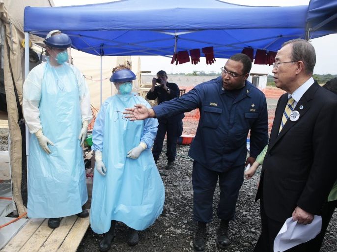 A handout picture made available by the United Nations (UN) shows UN Secretary-General Ban Ki-moon (R) taking a tour of a US medical facility in Monrovia, Liberia, 19 December 2014. Ban is on a trip to several West African countries affected by Ebola. EPA/UN PHOTO/EVAN SCHNEIDER