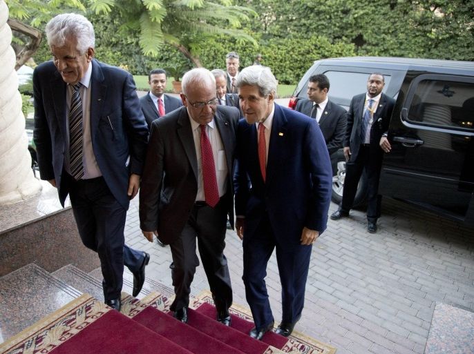 U.S. Secretary of State John Kerry (R) is greeted by Palestinian negotiator Saeb Erakat (C) and Palestinian Ambassador to Cairo Gamal Shoubaki as he arrives to meet with Palestinian President Mahmoud Abbas at Andalus Villa in Cairo October 12, 2014, on the sidelines of the Gaza Donor Conference. REUTERS/Carolyn Kaster/Pool (EGYPT)