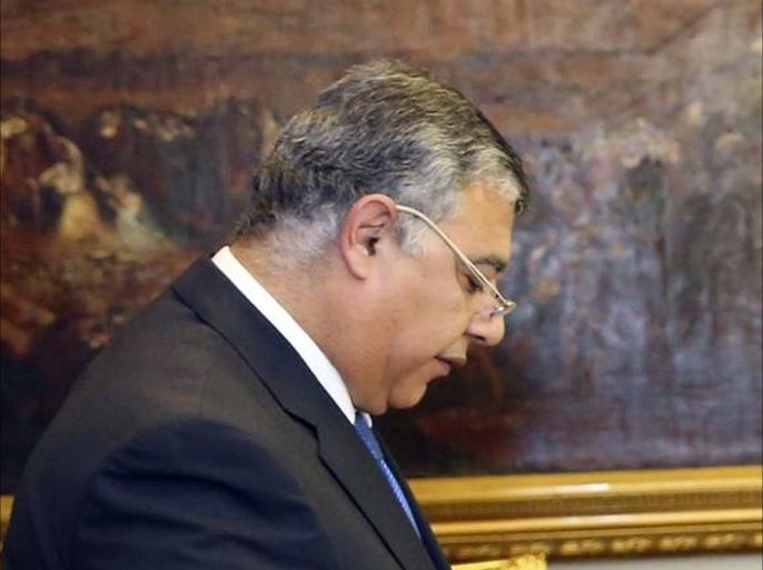 In this photo provided by Egypt's state news agency MENA, Egyptian President Abdel-Fattah el-Sissi, right, swears in Maj. Gen. Khaled Fawzy as acting intelligence chief in Cairo, Egypt, Sunday, Dec. 21, 2014. El-Sissi awarded intelligence chief Gen. Farid el-Tohamy the Republic Award, one of the state's highest awards, in his office Sunday after ordering his retirement. El-Sissi then swore in el-Tohamy's replacement, Fawzy, as acting intelligence chief. (AP Photo/MENA, Mohammed Samaha)