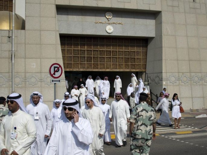 Ten of Kuwait Central Bank's employees walk out to demonstrate outside the bank in Kuwait City in this September 28, 2011 file photo. Political turmoil in Kuwait may eventually clear the way for better policy-making that boosts growth in the underperforming economy, though for now, fund managers fear it will deter fresh investment in Kuwaiti assets. To match Mideast Money KUWAIT-INVESTMENT/POLITICS.