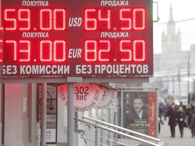 Information board displays currency exchange rates in Moscow, Russia, 19 December 2014. Euro and U.S. dollar lost their positions against ruble on the background of President Vladimir Putinâs end-of-the year news conference held on 18 December, but on 19 December resumed their growth up from the previous exchange rates.