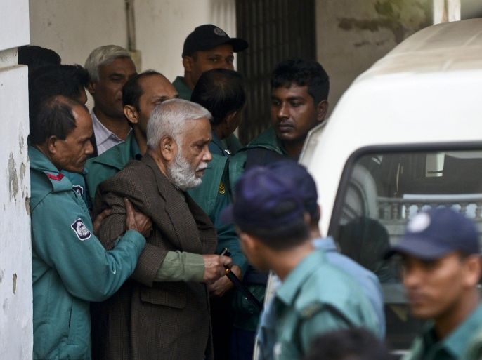 Bangladesh's former Jatiya Party minister Syed Mohammed Kaiser is taken into a van following his verdict at a special court in Dhaka on December 23, 2014. Bangladesh's war crimes court on December 23 sentenced a former government minister to hang for rape and genocide during the 1971 independence struggle against Pakistan. Syed Mohammad Kaiser became the 15th person to be convicted of atrocities by the International Crimes Tribunal, which found him guilty of heading a militia that rounded up and killed some 150 people in the nine-month conflict. AFP PHOTO/ MUNIR UZ ZAMAN