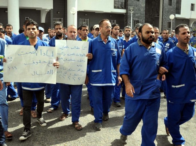 GAZA CITY, GAZA - SEPTEMBER 24: Hospital cleaning workers who stage a three-day-strike all around Gaza Strip to demand their five months of overdue salaries from the Palestinian Health Ministry protest at Al-Shifa Hospital of Gaza City, Gaza on September 24, 2014.