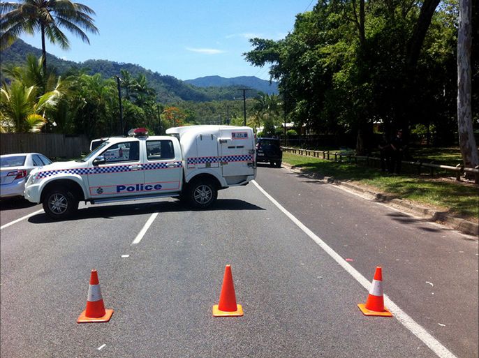 epa04534378 A police car blocks a street at an address in Manoora where up to eight victims have reportedly been stabbed to death, near Cairns, far north Queensland, Australia, 19 December 2014. It is believed seven of the victims are children, while it's understood a woman has been taken to hospital with stab wounds. EPA/CLEO FRASER AUSTRALIA AND NEW ZEALAND OUT