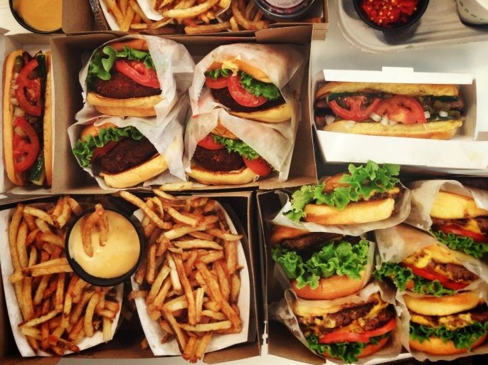 High angle view of take out food including burgers and fries
