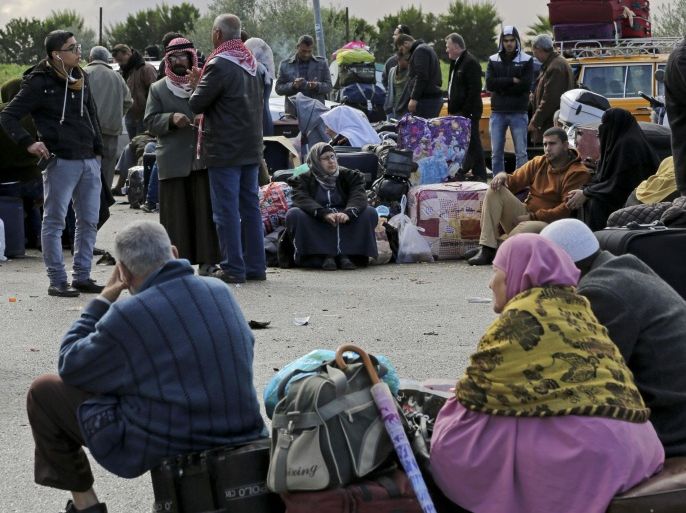 Palestinians sit on their luggage while waiting to cross the border to the Egyptian side at Rafah crossing in the southern Gaza Strip, Sunday, Dec. 21, 2014. In the Gaza Strip, a Palestinian border official said Egypt opened its border crossing with Gaza for the first time in two months, offering temporary relief to Palestinians seeking to leave the coastal enclave. (AP Photo/Adel Hana)