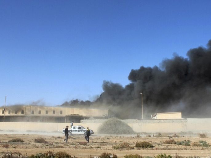 Black smoke billows from a warehouse after an airstrike in Zawura, December 2, 2014. At least three people were killed on Tuesday in air strikes on a town west of Tripoli carried out by forces loyal to Libya's internationally recognised government, which is in conflict with a rival force controlling the capital, officials said. The strikes targeted three locations in the Zawura city, including a food supply storage area, a fishing port and another unspecified target outside of the city, according to the local authorities and a military official. REUTERS/Stringer (LIBYA - Tags: CIVIL UNREST POLITICS)