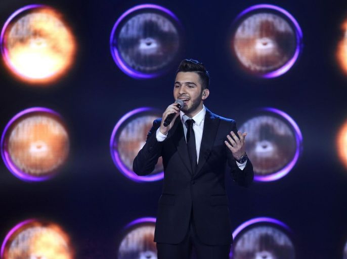 Syrian singer Hazem Sharif, 21, from Aleppo in northern Syria, performs during the the last prime of Arab Idol Show broadcast by MBC Arabic satellite channel in Zouk Mosbeh neighborhood, north of Beirut, Lebanon, Saturday, Dec. 13, 2014. Sharif was crowned the most watched show in the Middle East, beating off his two rivals Palestinian Haitham Khalaily and Majed Al-Madani from Saudi Arabia. (AP Photo/Bilal Hussein)