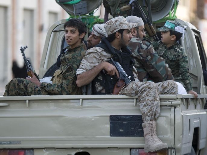 Houthi Shiite fighters wearing an army uniform ride on a pickup vehicle as they patrol a street during a demonstration to show support for their comrades in Sanaa, Yemen, Friday, Jan. 23, 2015. Thousands of protesters demonstrated Friday across Yemen, some supporting the Shiite rebels who seized the capital and others demanding the country's south secede after the nation's president and Cabinet resigned. (AP Photo/Hani Mohammed)