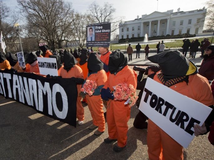 Protestors dressed as Guantanamo detainees gather in front of the White House, Sunday, Jan. 11, 2015, in Washington, during a rally to mark the 13th anniversary of detainees at Guantanamo Bay. (AP Photo/Manuel Balce Ceneta)