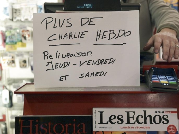 A sign which translates as 'Charlie Hebdo - Sold Out - Next deliveries on Thursday, Friday and Saturday' is displayed at a newsagents in Strasbourg on January 14, 2015 as the latest edition of French satirical weekly goes on sale. The first issue of satirical magazine Charlie Hebdo to be published since a jihadist attack decimated its editorial staff last week was sold out within minutes at kiosks across France. AFP PHOTO/FREDERICK FLORIN