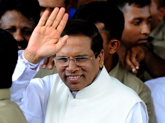 Sri Lanka's newly elected president Maithripala Sirisena waves to supporters as he leaves the Election Commission office in the capital Colombo on January 9, 2015. Maithripala Sirisena will be sworn in as Sri Lanka's new president January 9 after the strongman incumbent Mahinda Rajapakse conceded defeat in a bitterly fought election, brought down by charges of corruption and growing authoritarianism. AFP PHOTO / ISHARA S. KODIKARA
