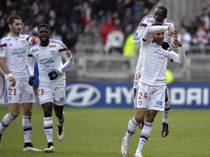 Lyon's French midfielder Corentin Tolisso (R) celebrates after scoring during the French L1 football match Olympique Lyonnais (OL) vs FC Metz (FCM) on January 25, 2015, at the Gerland Stadium in Lyon, central-eastern France. AFP PHOTO / JEFF PACHOUD