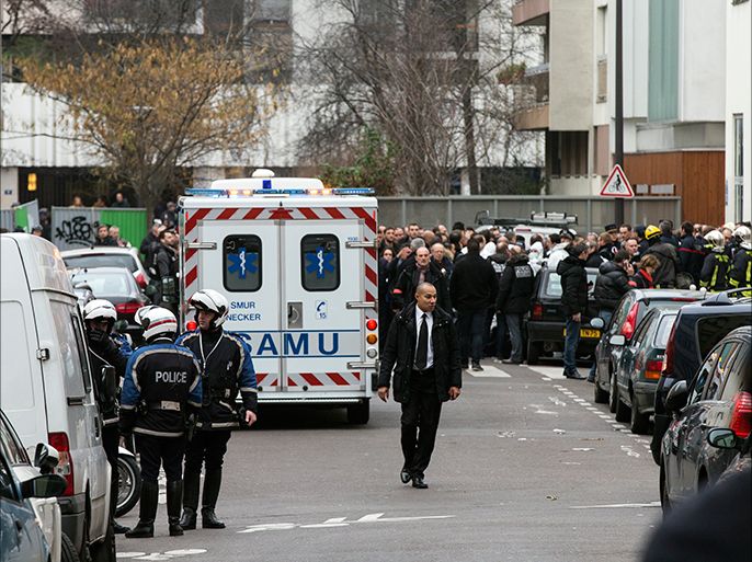 epa04549516 Policemen and rescue workers are near the site of an armed attack at the headquarters of French satirical magazine 'Charlie Hebdo', in Paris, France, 07 January 2015. According to news reports, several people have been killed in a shooting attack at satirical French magazine Charlie Hebdo in Paris. EPA/ETIENNE LAURENT
