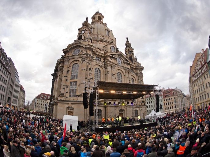 Thousands of people take part in a rally themed 'For Dresden, for Saxony - living together in the sense of a global awareness, humanity and dialogue ' on January 10, 2015 in front of the Frauenkirche (Church of Our Lady) in Dresden, eastern Germany. The rally was organised as a response to the anti-Islamic Pegida movement, that plans to rally again on Monday, January 12, 2015. Analysts expect Pegida's ranks to swell by thousands following this week's bloody jihadist violence in France. AFP PHOTO / DPA / ARNO BURGI +++ GERMANY OUT