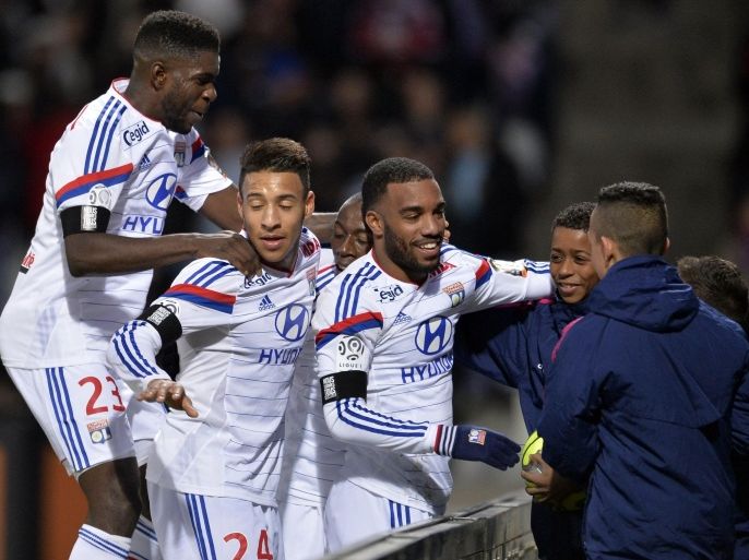 Lyon's French forward Alexandre Lacazette (C) is congratulated by teammates after scoring a goal during the French L1 football match Lyon (OL) vs Toulouse (TFC) on January 11, 2015 at the Gerland stadium in Lyon. AFP PHOTO PHILIPPE MERLE