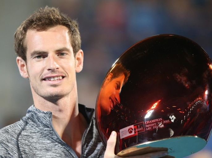 Andy Murray of Britain poses with the winners trophy after Novak Djokovic of Serbia pulls out of the final match at the Mubadala World Tennis Championship 2015 in Abu Dhabi, United Arab Emirates, 03 January 2015.