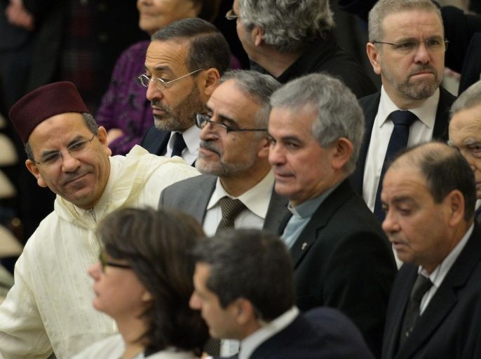 The President of the French Council of Muslim Faith, Mohammed Moussaoui (L), the rector of Bordeaux mosque, Tareq Oubrou (top, 2ndL), the rector of the Villeurbanne mosque, Azzedine Gaci (topR) and the director of the theology institut of the Great Mosque of Paris, Djelloul Seddiki (C), arrive to attend Pope Francis' weekly general audience at the Paul VI hall on January 7, 2015 at the Vatican. AFP PHOTO / ALBERTO PIZZOLI