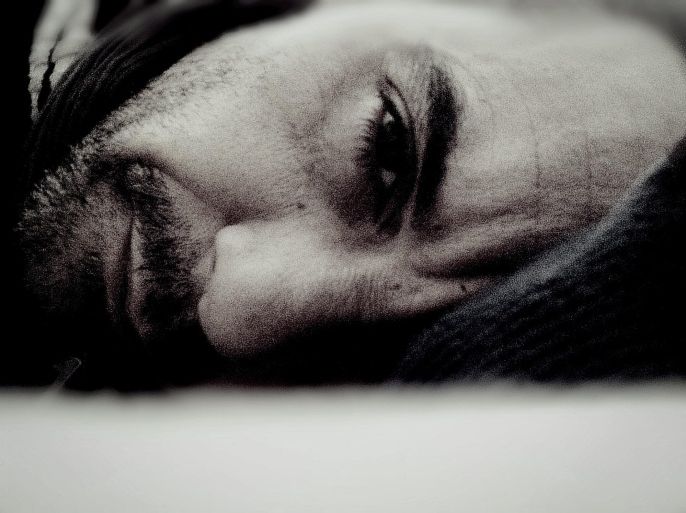 Close-up portrait of young man lying in bed