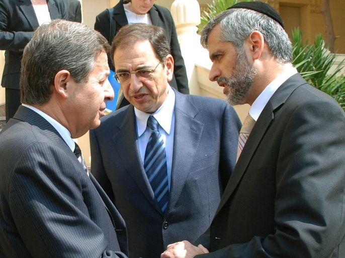 Israeli deputy Prime Minister and Minister of Industry Eli Yishai (R), says good-bye to his Egyptian counterpart Trade Minister Rashid Mohammed Rashid (L) after meeting Egyptian President Hosni Mubarak in Cairo 09 October 2006. Sharon Cohen, Israeli ambassador to Egypt stands between them. Egypt and Israel signed a deal to lower the threshold of Israeli components required in Egyptian products for them to be exported to the United States duty-free. Goods from a Qualifying Industrial Zones (QIZ), several of which exist in Egypt and Jordan since the US Congress authorized them in 1996, can enter the United States duty-free provided they contain Israeli components.