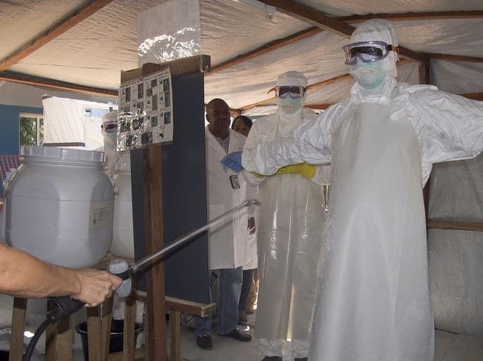 A photograph made availabe on 17 November 2014 shows health workers from Mali getting sprayed with disinfectant at the Ebola isolation centre that was inaugurated on the grounds of the former leprosy hospital in Bamako, Mali, 11 November 2014. The same evening the Ebola isolation centre received its first patient, a radiologist from the city's Pasteur Clinic who had been in contact with a traditional muslim healer who died at the clinic on 27 October without being tested for Ebola. The paramedic has since tested positive for Ebola. The United Nations mission in Mali has cancelled its contract with the Pasteur Clinic which provided care to its peacekeepers after this case of Ebola was missed and spread from there. Authorities are trying to trace over 400 potential fresh contacts.