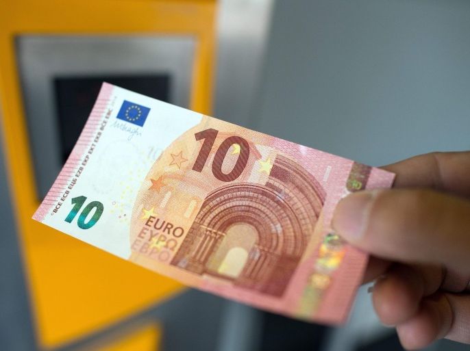 A person holds a 10 euro note in Bonn, Germany, 23 September 2014. The new ten Euro note comes into circulation. The bank note will be harder to forge and is expected to last longer.