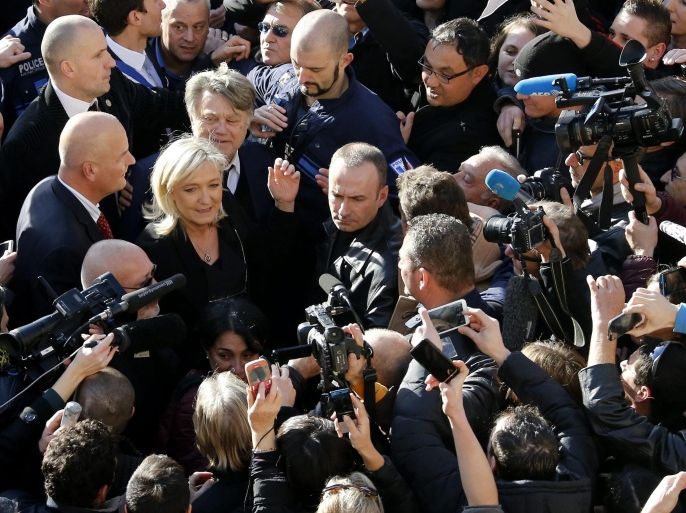 Leader of the French party National Front (FN) Marine Le Pen (2-L) speaks to media as she attends a meeting to honor the victims of the terrorist attacks and to show unity, in Beaucaire, Southern France, 11 January 2015. Three days of terror that ended on 10 January saw 17 people killed in attacks that began with gunmen invading French satirical magazine Charlie Hebdo and continued with the shooting of a policewoman and the siege of a Jewish supermarket.