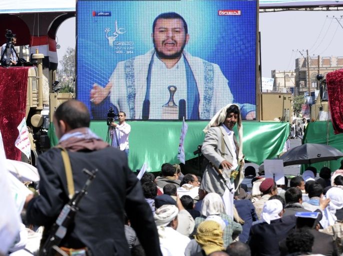 SANAA, YEMEN - OCTOBER 12: Houthis listen a televised speech by group leader Abdel-Malek al-Houthi featured on a large screen during the celebrations of Shiite Muslims' Eid al-Ghadeer holiday in Sanaa, Yemen on 12 October, 2014. This is the first time for Houthis to hold an elaborate celebration of a Shiite holiday in Sanaa.