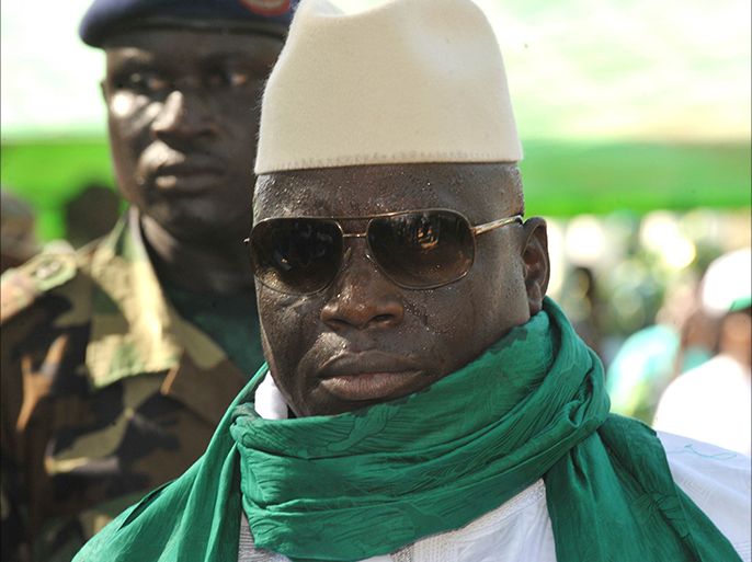 (FILES)-- A file photo taken on November 22, 2011 shows Gambian President Yahya Jammeh greets supporters during a rally in Gambia. A military coup bid in the small west African state of The Gambia was foiled early on December 30, 2014, while President Yahya Jammeh was abroad, military and diplomatic sources said. "Members of the Gambian armed forces have been involved in serious (gunfire) around 3:00 am. They wanted to overthrow the regime," a military source said, while a Western diplomat said that presidential guard troops were among forces who attacked Jammeh's palace. AFP PHOTO / SEYLLOU