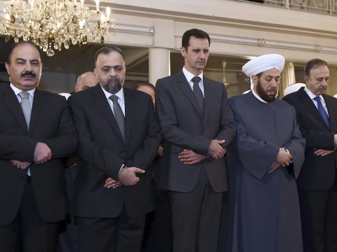Syria's President Bashar al-Assad (C) prays during a religious ceremony on the occasion of Prophet Mohammed's birthday at Al-Afram mosque in Damascus January 4, 2015, in this handout photograph released by Syria's national news agency SANA. Assad prayed at the mosque in the capital Damascus on Sunday, state television reported, the latest of several recent public appearances. REUTERS/SANA/Handout via Reuters (SYRIA - Tags: CIVIL UNREST POLITICS RELIGION CONFLICT) ATTENTION EDITORS - THIS PICTURE WAS PROVIDED BY A THIRD PARTY. REUTERS IS UNABLE TO INDEPENDENTLY VERIFY THE AUTHENTICITY, CONTENT, LOCATION OR DATE OF THIS IMAGE. FOR EDITORIAL USE ONLY. NOT FOR SALE FOR MARKETING OR ADVERTISING CAMPAIGNS. THIS PICTURE IS DISTRIBUTED EXACTLY AS RECEIVED BY REUTERS, AS A SERVICE TO CLIENTS